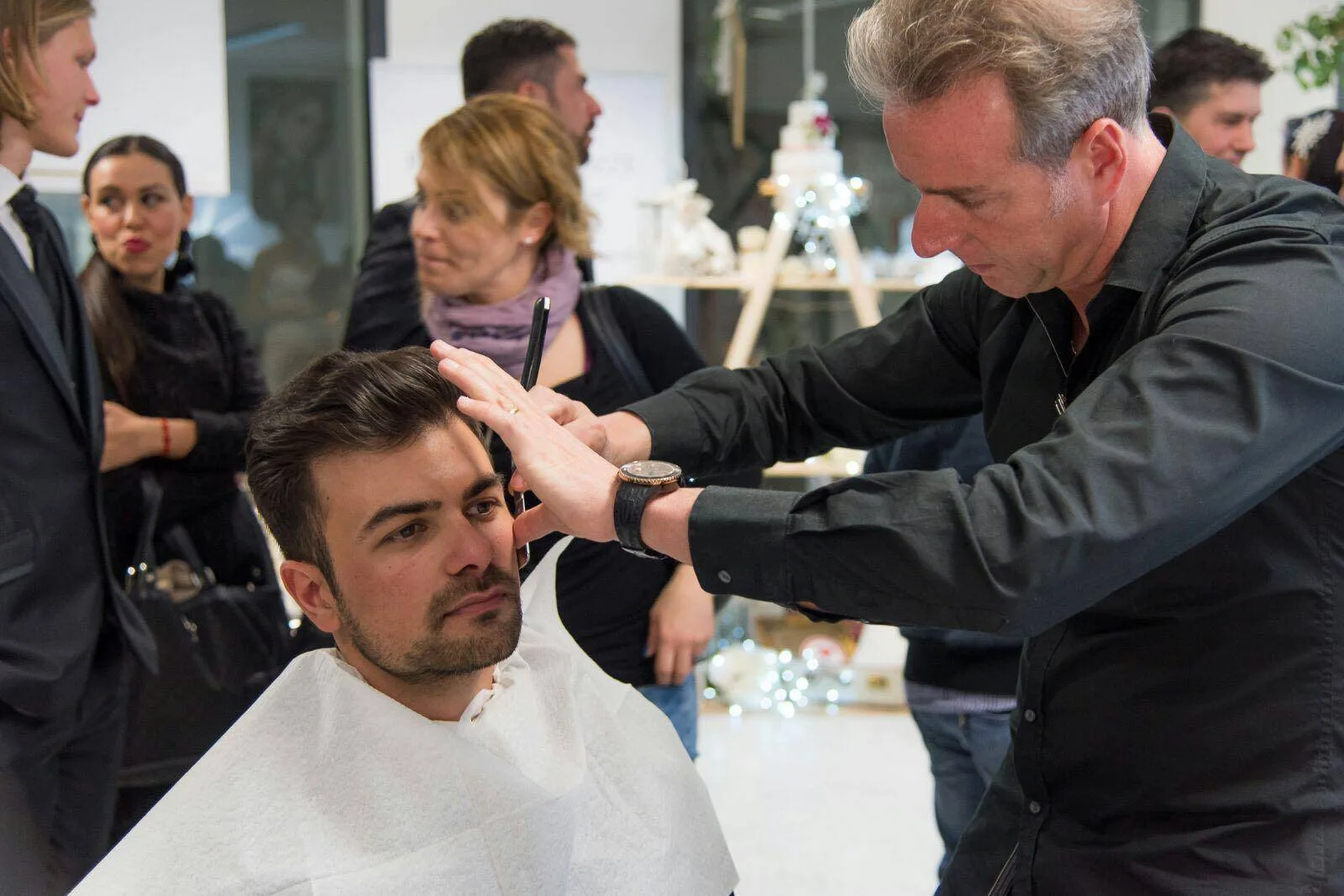 Barbiere al lavoro durante un taglio nello studio